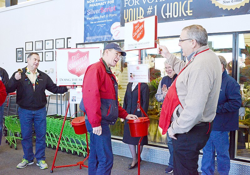Brian Johnson, center, makes a donation as Fechtel Beverage President Bernie Fechtel, right, and Lt. Gov. Mike Kehoe, left, compete during a Red Kettle Ring-Off rematch in 2018 at Hy-Vee Supermarket. The match helps raise funds toward the Salvation Army Red Kettle Campaign.
