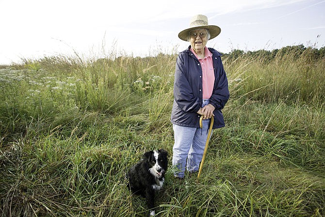 Pat Jones and Angus stand on the prairie land she donated to Missouri Department of Conservation. She died on Monday.