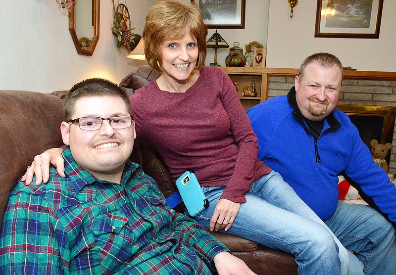 Marcia and Jeff Patridge and their son, Tylar, who is deaf, pose for a photo. Tylar works at Capitol Projects.