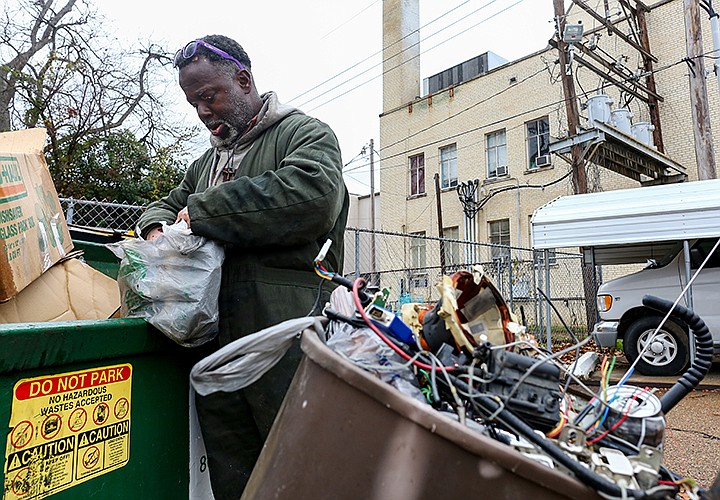 Dana Belin, 53, searches through bags from the trash bin looking for cans and anything that has metal to sell for money on Wednesday, Dec. 19, 2018,  in Texarkana, Texas. Belin has been scrapping for metal for two years around the city to make a living, putting in 50 to 60 hours a week, while being homeless. Belin lives in the woods and he walks 7 to 9 miles everyday to search trash bins for items containing metal parts that can be sold for money. "Some people think homeless people are worthless; maybe society is worthless. All I know, homelessness isn't a problem that will go away," Belin 
said. Staff photo by Hunt Mercier 