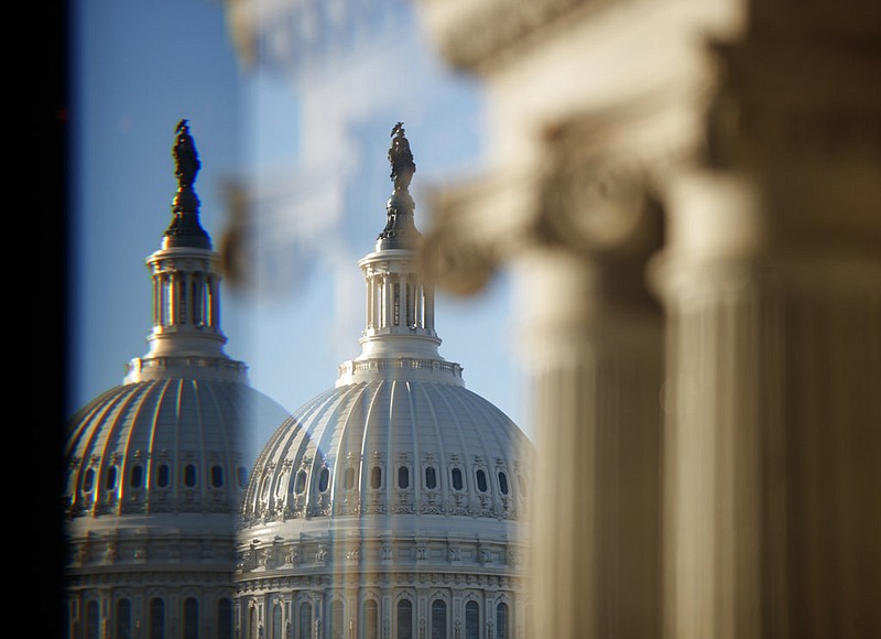 The U.S. Capitol Building Dome is seen through a beveled window at the Library of Congress in Washington, Wednesday, Dec. 19, 2018. 