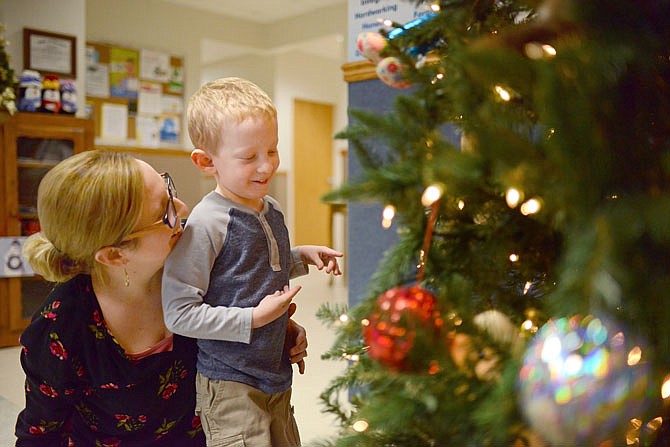 Henry Ready, 5, looks at Christmas tree decorations with his mom, Kara, at the Special Learning Center. Henry was diagnosed with lissencephaly and Walker-Warburg syndrome, which causes severe delays in growth and development, but he has surpassed many of the doctors expectations.