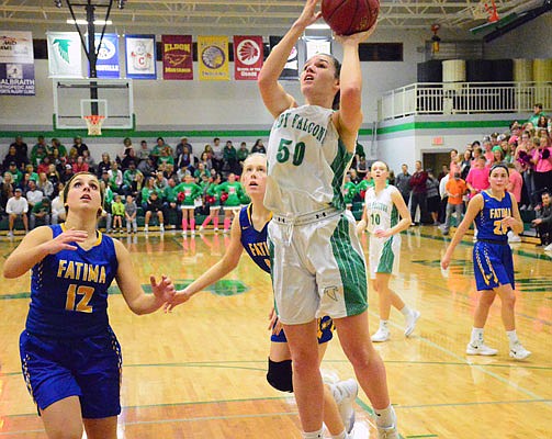 Brooke Boessen of Blair Oaks takes a shot as Morgan Laux of Fatima looks for a potential rebound during Friday night's game in Wardsville.