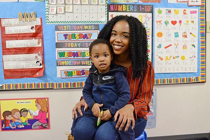 Evelyn Zayumba sits with her son, Ronald Bolden III, in his classroom at Little Explorers Discovery Center.