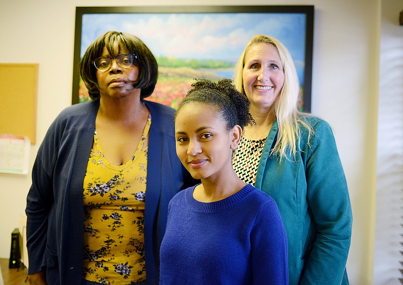 From left, Marsha Allen, Mahlet Gemechu and Joy Sweeney stand together Dec. 13 at the Council for Drug Free Youth office building. 