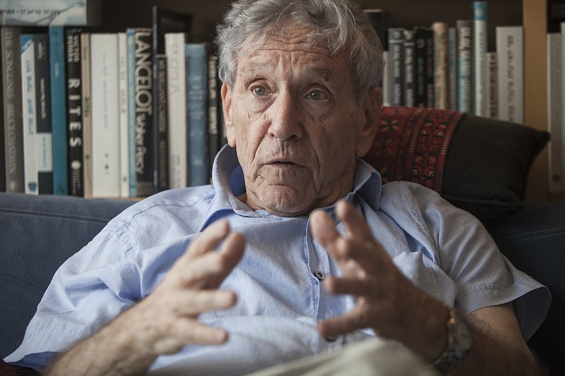 FILE - In this Nov. 4, 2015 file photo, Israeli writer Amos Oz poses for a photo at his house in Tel Aviv, Israel. Israeli media said Friday, Dec. 28, 2018 that renowned Israeli author Amos Oz has died at the age of 79. Oz, author of novels, prose and a widely acclaimed memoir, had suffered from cancer. Oz won numerous prizes, including the Israel Prize and Germany’s Goethe Award, and was a perennial contender for the Nobel Prize in literature. (AP Photo/Dan Balilty, File)