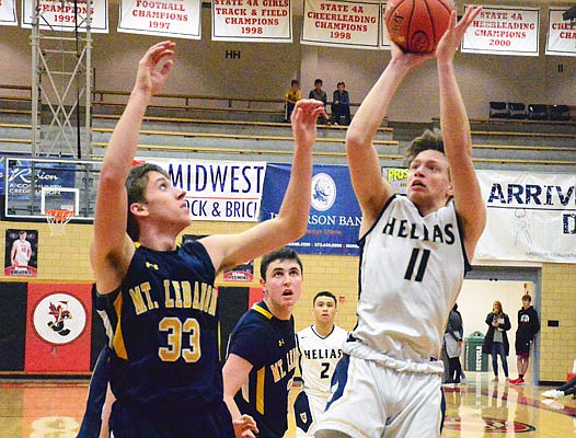 Caleb Justice of the Helias Crusaders puts up a shot against the defense of Jake Hoffman of Mt. Lebanon (Pa.) during the game Dec. 27, 2018, in the Joe Machens Great 8 Classic at Fleming Fieldhouse.