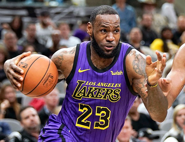 In this Dec. 7 file photo, LeBron James of the Lakers drives against the Spurs during the first half of a game in San Antonio.