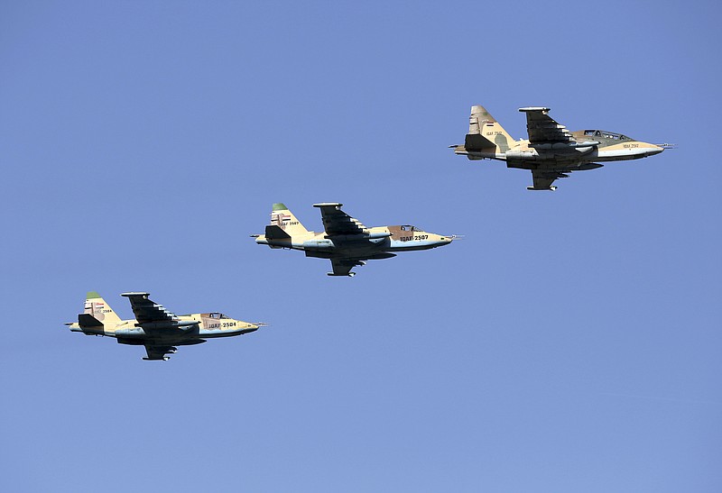 FILE -  In this July 14, 2016, file, photo, Iraqi Air Force jets take part in a military parade in Baghdad, Iraq. Syria’s state news agency said Sunday, Dec. 30, 2018 that President Bashar Assad has authorized Iraqi forces to attack the Islamic State group inside Syria without waiting for permission from authorities in Damascus.  (AP Photo/Hadi Mizban, File)