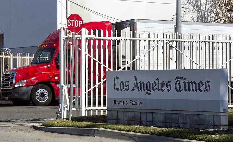A truck is parked outside the Los Angeles Times Olympic Facility in Los Angeles, Sunday, Dec. 30, 2018. A computer virus hit the newspaper printing plant in Los Angeles, and at Tribune Publishing newspapers across the country. (AP Photo/Damian Dovarganes)