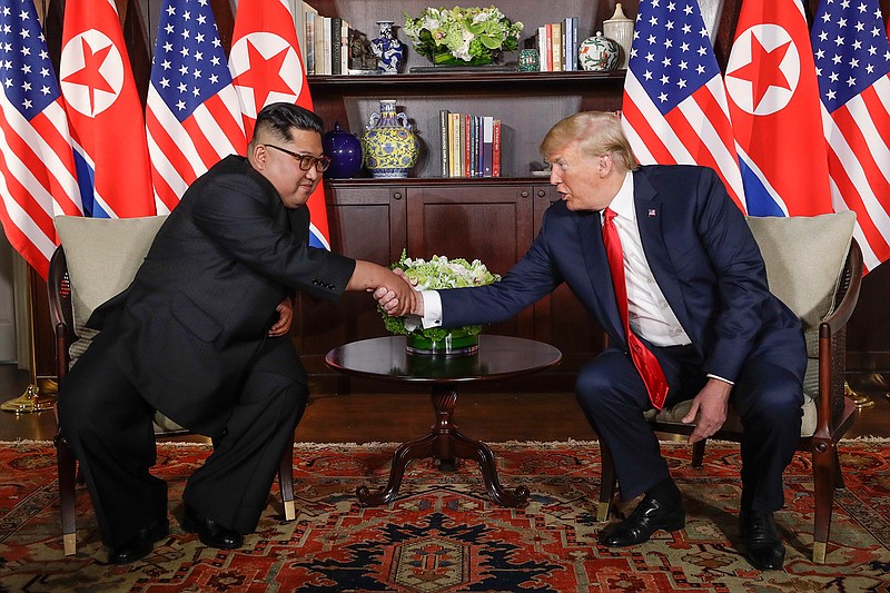 In this Tuesday, June 12, 2018, file photo, North Korea leader Kim Jong Un, left, and U.S. President Donald Trump shake hands during their first meeting at the Capella resort on Sentosa Island in Singapore. (AP Photo/Evan Vucci, File)
