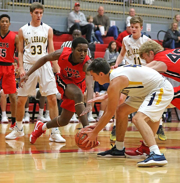 Hayden Mitchell of Mount Lebanon picks up a loose ball as Michael Appiah-Brefo of the Jays tries to slap it away during Saturday's third-place game of the Joe Machens Great 8 Classic at Fleming Fieldhouse.
