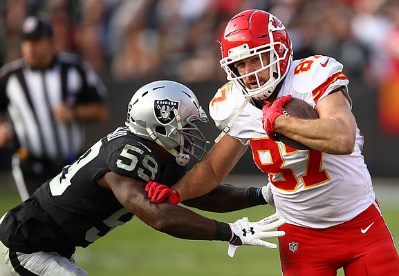 Chiefs tight end Travis Kelce tries to get away from Raiders linebacker Tahir Whitehead during a game earlier this month in Oakland, Calif. The Chiefs can win the AFC West and the No. 1 seed in the conference playoffs with a victory today against the Raiders at Arrowhead Stadium.
