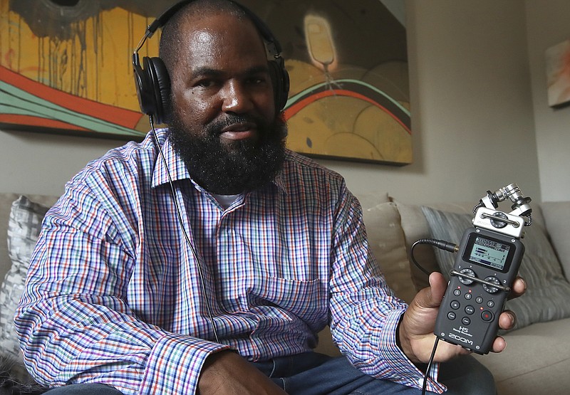 In this Dec. 19, 2018, photo, Earlonne Woods shows recording equipment similar to what he used in San Quentin State Prison to produce his podcasts, during an interview in Oakland, Calif. Woods, 47, was recently released from San Quentin prison after California Gov. Jerry Brown commuted his 31-years-to-life sentence for attempted armed robbery. Brown cited Woods' leadership in helping other inmates and his work at "Ear Hustle," a podcast he co-hosts and co-produces that documents everyday life inside the prison. "Ear Hustle" launched in 2017. Its roughly 30 episodes have been downloaded a total of 20 million times by fans all over the world. (AP Photo/Ben Margot)