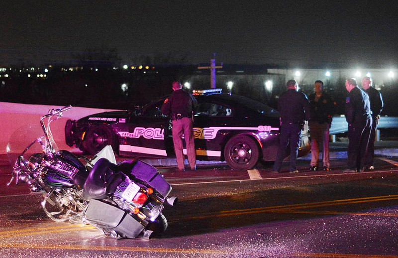 In this Jan. 2, 2019 photo, emergency personnel respond to a crash involving multiple vehicles and a Catoosa police officer who was on foot in Catoosa, Okla. The National Weather Service has issued a winter storm warning through Friday morning for northern Texas and much of Oklahoma. (Stetson Payne/Tulsa World via AP)