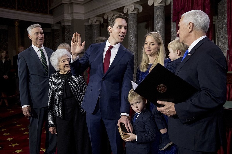 Vice President Mike Pence administers the Senate oath of office to Sen. Josh Hawley, R-Mo., accompanied to his wife Erin Morrow, third from right, and other members of his family during a mock swearing in ceremony in the Old Senate Chamber on Capitol Hill in Washington, Thursday, Jan. 3, 2019, as the 116th Congress begins. (AP Photo/Andrew Harnik)