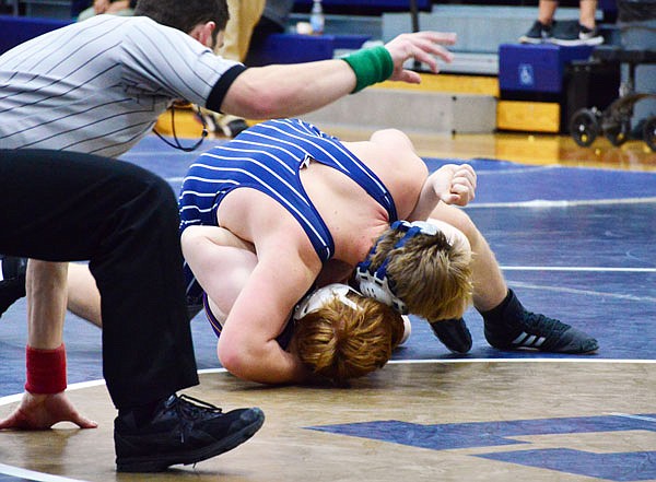 Curtis Rockers of Helias rolls a Camdenton wrestler onto his back during Wednesday night's dual at Rackers Fieldhouse.