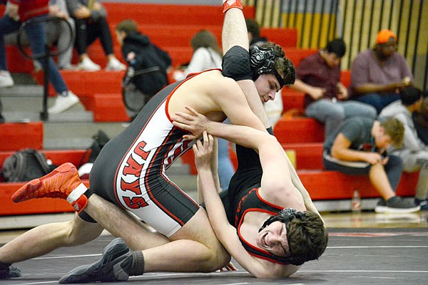 Jefferson City's Brant Aulber flips Ozark's Colby Allen onto his back during their match at 182 pounds in Thursday night's dual at Fleming Fieldhouse.