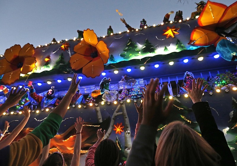 FILE - In this Feb. 25, 2017 file photo, revelers scream for beads during the Krewe of Endymion Mardi Gras parade in New Orleans. The rest of America may be winding down from Christmas and New Year’s. But in New Orleans, another party is about to get started. Mardi Gras season kicks off Sunday, Jan. 6, 2019. (AP Photo/Gerald Herbert, File)