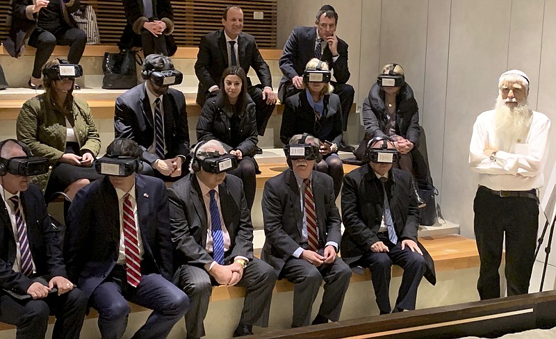 U.S. National Security Adviser John Bolton, seated front row forth from left, participates in a virtual reality demonstration at the Western Wall on Sunday, Jan. 6, 2019, in Jerusalem. U.S. Ambassador to Israel David Friedman and Israeli Ambassador to the U.S. Ron Dermer are sitting alongside. (AP Photo/Zeke Miller)