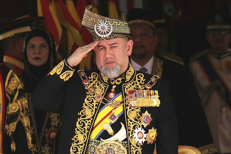FILE - In this July 17, 2018, file photo, Malaysian King Sultan Muhammad V salutes during the national anthem at the opening of the 14th parliament session at the Parliament house in Kuala Lumpur, Malaysia.  Muhammad V has abdicated in an unexpected and rare move, just after two years on the throne. The palace said in a statement on Sunday, Jan. 6, 2019, that Sultan Muhammad V, 49, has resigned with immediate effect, cutting short his five-year term, without giving any reasons. Sultan Muhammad V, ruler of northeast Kelantan state, was installed in December 2016 as one of the country's youngest constitutional monarchs. (AP Photo/Yam G-Jun, File)