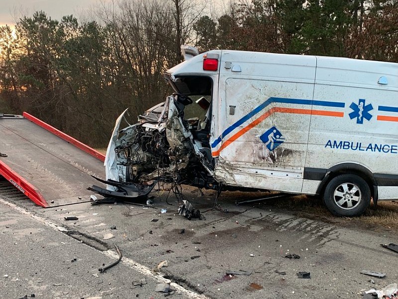 An ambulance is pulled onto a wrecker after it was struck head-on in a collision on Interstate 40 on Sunday morning.