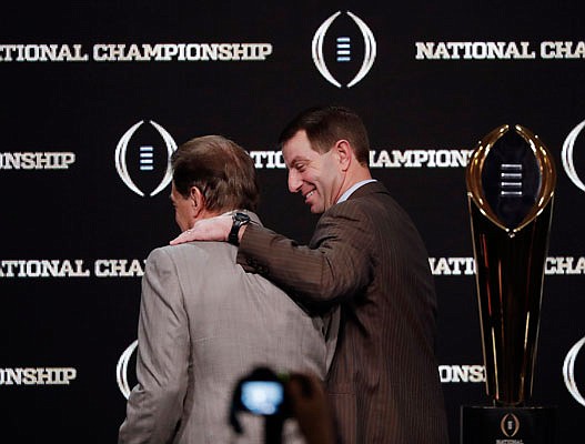 Clemson coach Dabo Swinney puts his arm around Alabama coach Nick Saban as they leave a press conference Sunday in Santa Clara, Calif.