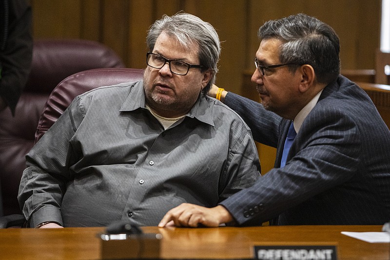 Jason Dalton talks with his defense attorney Eusebio Solis moments before pleading guilty to six counts of murder and several other charges at the Kalamazoo County Courthouse on Monday, Jan. 7, 2019 in Kalamazoo, Michigan. Dalton, who was driving for Uber at the time shot eight people killing six of them, on Saturday, Feb. 20, 2016. Opening statements in the trial were scheduled to begin Tuesday, Jan. 8. (Joel Bissell/Kalamazoo Gazette via AP)
