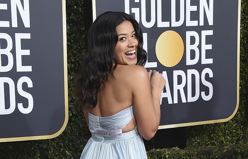 Gina Rodriguez poses on the red carpet with a ribbon that reads Time's Up as she arrives at the 76th annual Golden Globe Awards at the Beverly Hilton Hotel on Sunday, Jan. 6, 2019, in Beverly Hills, Calif. (Photo by Jordan Strauss/Invision/AP)