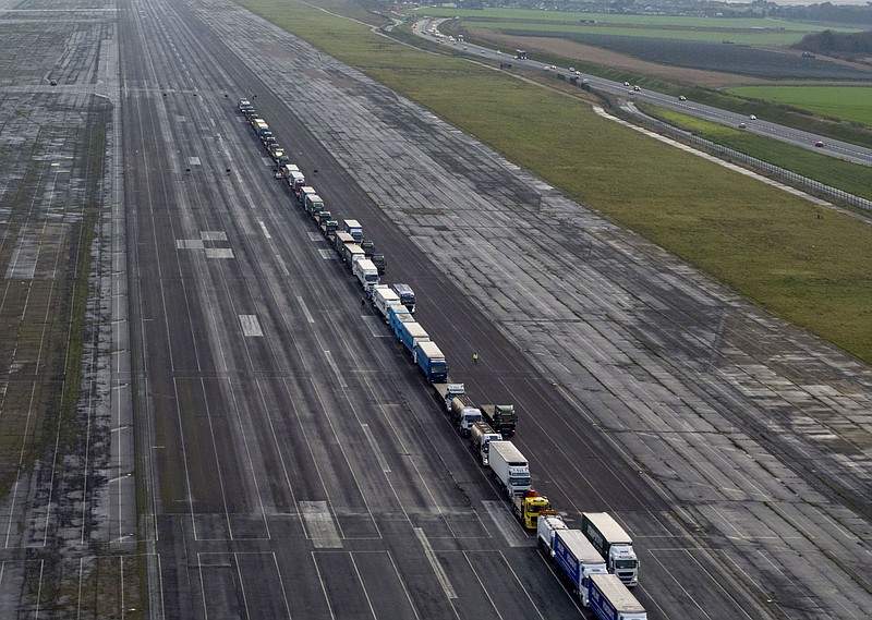 Some 150 trucks are parked at Manston Airfield during a test for a 'no-deal' Brexit, where 6,000 trucks could be parked at the airfield near Ramsgate in south east England, Monday, Jan. 7, 2019.  The former airfield at Manston could be used as part of the government plan to park some 6,000 trucks to alleviate expected congestion at the channel ports, about 25 miles (40 Km) from the airfiled, caused by the reintroduction of customs checks on goods in the event of Britain making a no-deal withdrawal from the European Union at the end of March. (Victoria Jones/PA via AP)