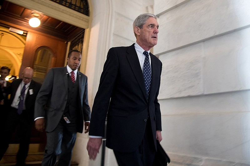 Former FBI Director Robert Mueller, front, the special counsel probing Russian interference in the 2016 U.S. election, leaves the Capitol building after meeting with the Senate Judiciary Committee on Capitol Hill on June 21, 2017 in Washington, D.C. A bill meant to protect Mueller from risk of improper termination is being reintroduced. (Ting Shen/Xinhua/Zuma Press/TNS)