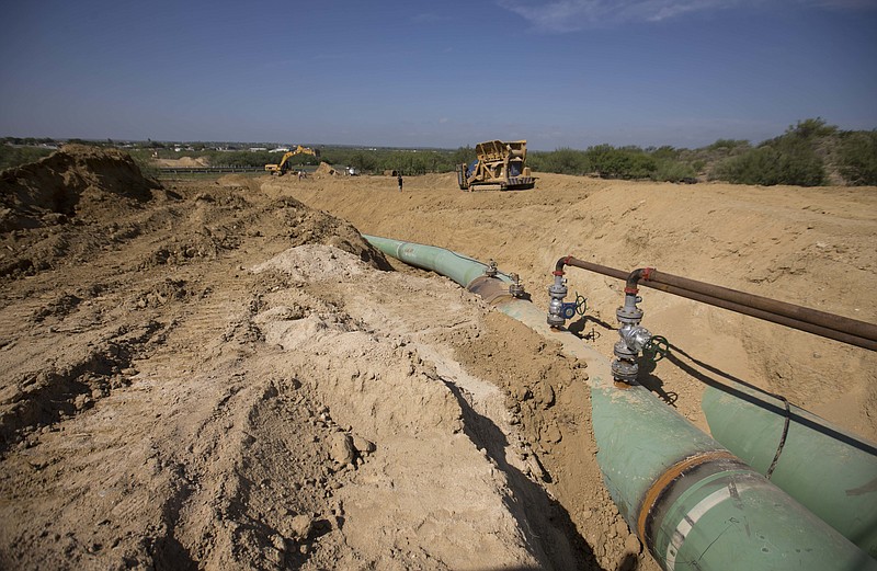 FILE - In this Sept. 7, 2014 photo, new pipelines to carry gas from Texas to Mexico, eventually reaching the city of Guanajuato, are laid underground near General Bravo, Nuevo Leon state, Mexico. Mexico’s President Andres Manuel Lopez Obrador said Monday, Jan. 7, 2019 that he has shut down some pipelines to stop fuel thieves who he says have established an illegal distribution network. (AP Photo/Eduardo Verdugo, File)