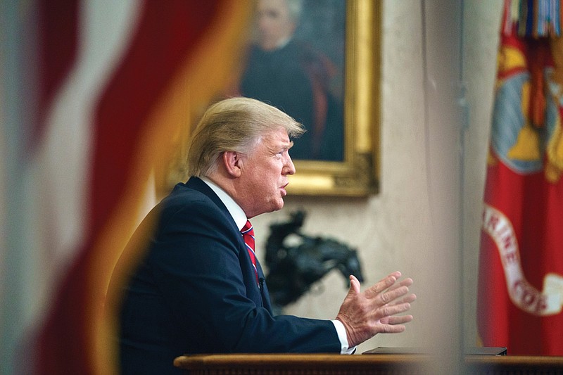 As seen from a window outside the Oval Office, President Donald Trump gives a prime-time address about border security Tuesday, Jan. 8, 2018, at the White House in Washington. (AP Photo/Carolyn Kaster)