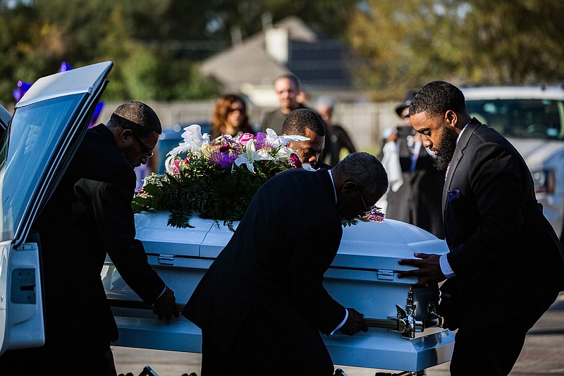 The casket of Jazmine Barnes is removed from the funeral hearse to be taken inside the Community of Faith Church for a memorial service, Tuesday, Jan. 8, 2019, in Houston. (Marie De Jesus/Houston Chronicle via AP)
