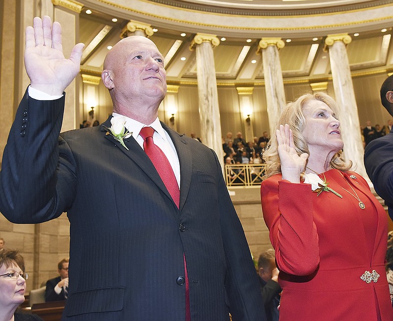 In this Jan. 9, 2019 photo, Sens. Mike Bernskoetter, R-Jefferson City, and Jeanie Riddle, R-Mokane, repeat their oath of office during opening day ceremonies of the Missouri Legislature. Bernskoetter previously served in the House of Representatives and is in his first term as a senator. Riddle was elected in 2008.