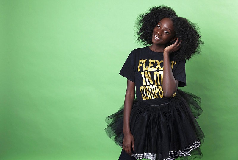 In this Dec. 19, 2018 photo, social media personality Kheris Rogers poses for a portrait in Los Angeles. Rogers launched her own fashion line with T-shirts sporting, "Flexin' in My Complexion," along with backpacks reading "The Miseducation of Melanin" and other apparel and accessories. (Photo by Rebecca Cabage/Invision/AP)