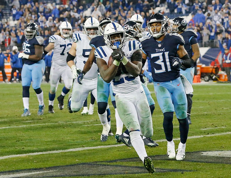 Colts running back Marlon Mack scores a touchdown on an 8-yard run ahead of Titans safety Kevin Byard during a game last month in Nashville, Tenn.