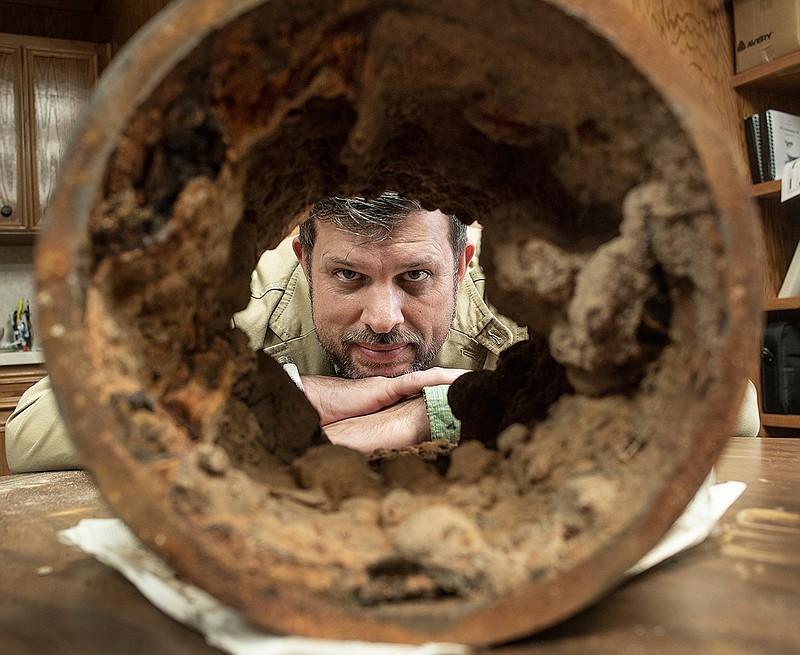 Rockdale's City Manager Chris Whittaker is pictured with an example of one of his city's corroded and rusted water pipes on Friday, December 21, 2018. Corroded pipes often lead to water from faucets being brown or red, causing many residents to purchase water rather than use tap water for drinking or cooking. The city's hospital also closed its doors this year. (Andy Sharp/Austin American-Statesman via AP)