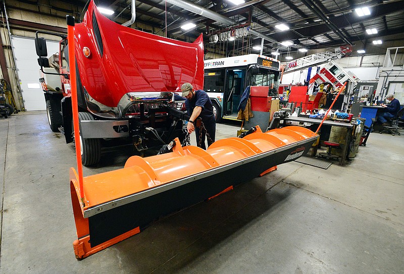 Wes Kampeter, a technician with Jefferson City Central Maintenance, performs a last-minute inspection on a snow plow Thursday before sending it out to combat Friday's possible snowfall.