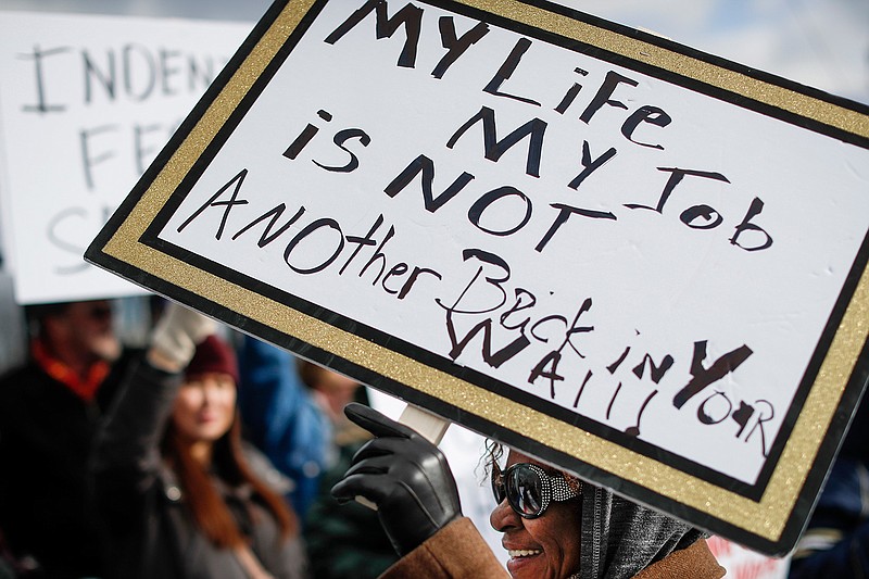 Union members and Internal Revenue Service workers rally outside an IRS Service Center to call for an end to the partial government shutdown, Thursday, Jan. 10, 2019, in Covington, Ky. (AP Photo/John Minchillo)