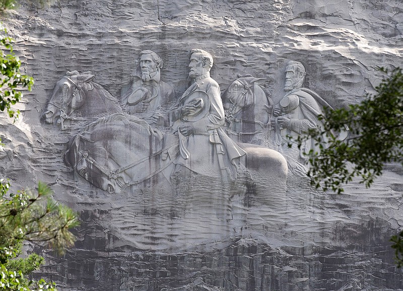 This June 23, 2015, file photo shows a carving depicting Confederates Stonewall Jackson, Robert E. Lee and Jefferson Davis in Stone Mountain, Ga. A coalition of civil rights groups in Atlanta is using this year's Super Bowl to kick off a renewed "war on the Confederacy," in a fight to remove Confederate monuments around the nation (AP Photo/John Bazemore, File)