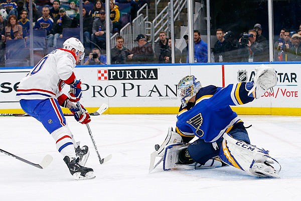 Blues goaltender Jordan Binnington stretches to stop a shot by Nicolas Deslauriers of the Canadiens during the first period of Thursday night's game in St. Louis.