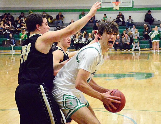 Eric Northweather of Blair Oaks starts a move against the defense of Quinn Randall of Versailles during Thursday night's game in Wardsville.