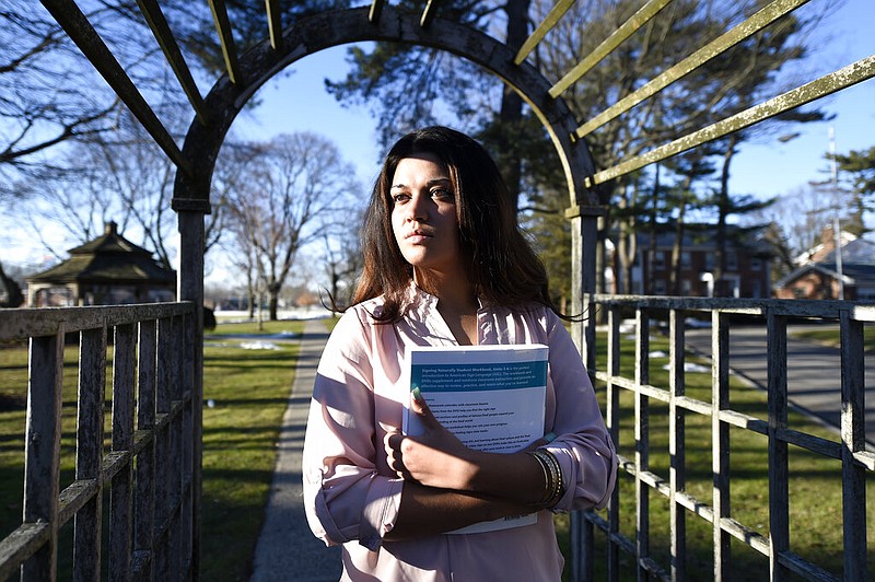  In this Feb. 2, 2016, file photo, Naila Amin, 26, holds a book from one of the classes she was taking at Nassau Community College in Garden City, N.Y. According to data provided to The Associated Press, the U.S. approved thousands of requests by men to bring child and teenage brides from another country. "My passport ruined my life," said Naila Amin, a dual citizen from Pakistan who grew up in New York City. She was forcibly married at 13 in Pakistan and applied for papers for her 26-year-old husband to come to the country. "People die to come to America. I was a passport to him. They all wanted him here, and that was the way to do it."