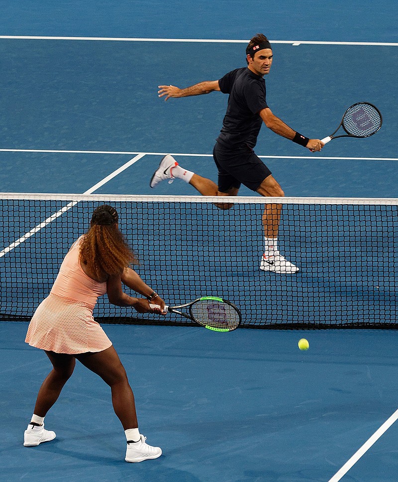 In this Jan. 1, 2019, file photo, Roger Federer of Switzerland returns the ball to Serena Williams of the United states during their mixed doubles tennis match at the Hopman Cup in Perth, Australia. It was a terrific moment for tennis, drawing tons of attention to an otherwise meaningless exhibition event and a recently dormant sport just starting its new season: Serena Williams and Roger Federer sharing a court. (AP Photo/Trevor Collens, File)