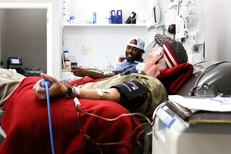 In this January 2019 file photo Robert Evans and Jimmy Roach converse while donating blood at the LifeShare Blood Center at 4020 Summerhill Road in Texarkana, Texas.