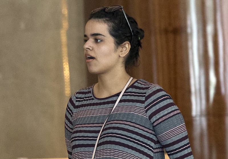 Rahaf Mohammed Alqunun walks in Bangkok, Thailand, Friday, Jan. 11, 2019. Alqunun, the 18-year old Saudi woman who fled her family to seek asylum, remains in Thailand under the care of the U.N. refugee agency as she awaits a decision by a third country to accept her as a refugee. (AP Photo/Sakchai Lalit)