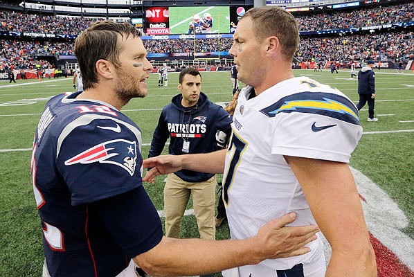 In this Oct. 29, 2017, file photo, Patriots quarterback Tom Brady and Chargers quarterback Philip Rivers speak at midfield following a game in Foxborough, Mass.