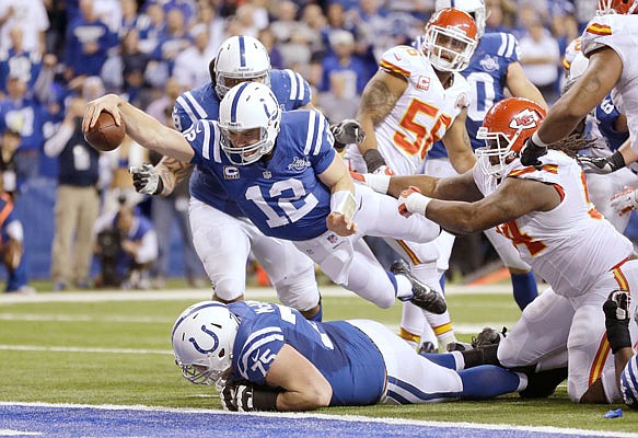 In this Jan. 4, 2014, file photo, Colts quarterback Andrew Luck dives for a touchdown after recovering a fumble during a playoff game against the Chiefs in Indianapolis.