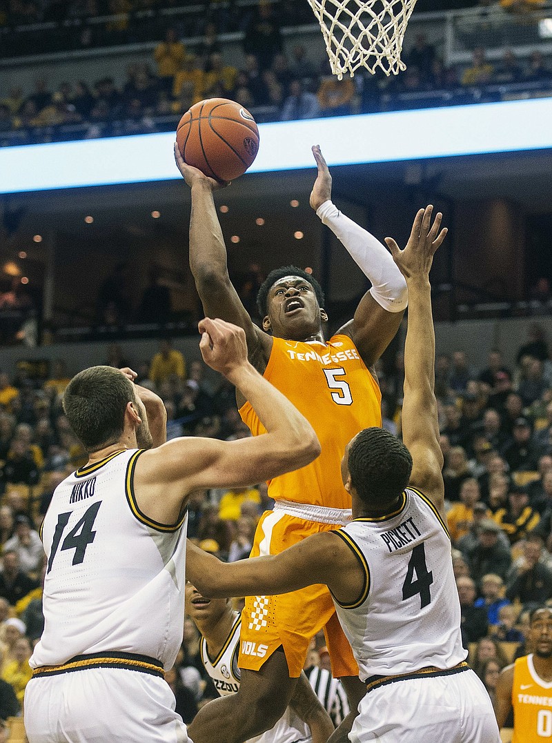 Tennessee's Admiral Schofield, top, shoots over Missouri's Reed Nikko, left, and Javon Pickett during the first half of an NCAA college basketball game Tuesday, Jan. 8, 2019, in Columbia, Mo. (AP Photo/L.G. Patterson)